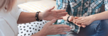 Close up look on hands of female psychotherapist and child